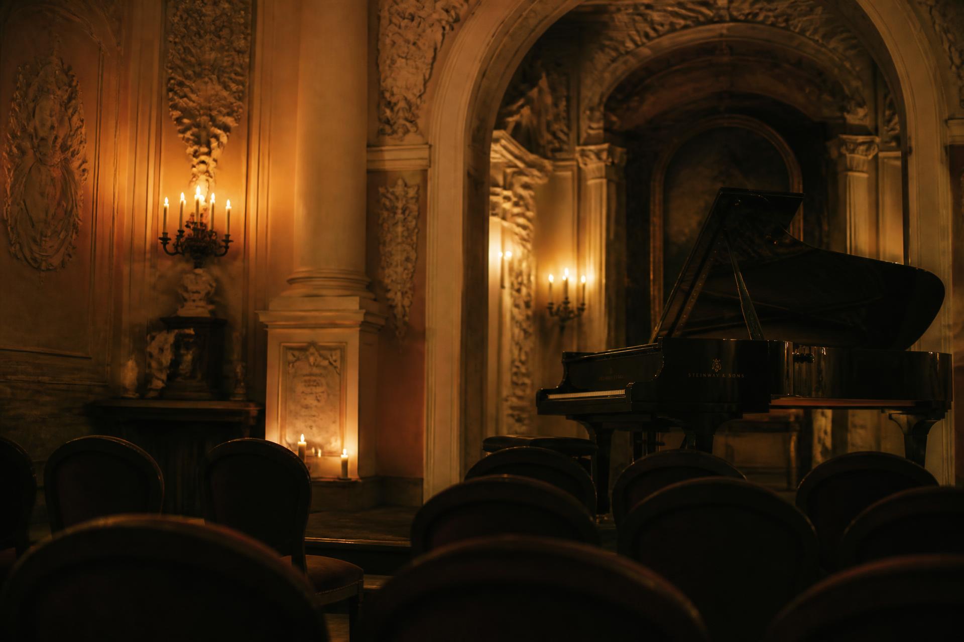 Candlelit grand piano awaiting an intimate Chopin concert in a historic Krakow interior